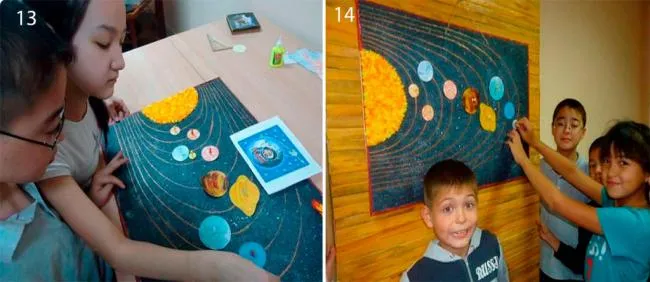 Дети вешают на стенку бумажный макет Солнечной системы